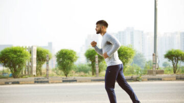 Young man jogging on city street in fresh morning air